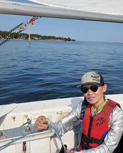 Photo of me in Martin 26 sailboat & open ocean behind me.