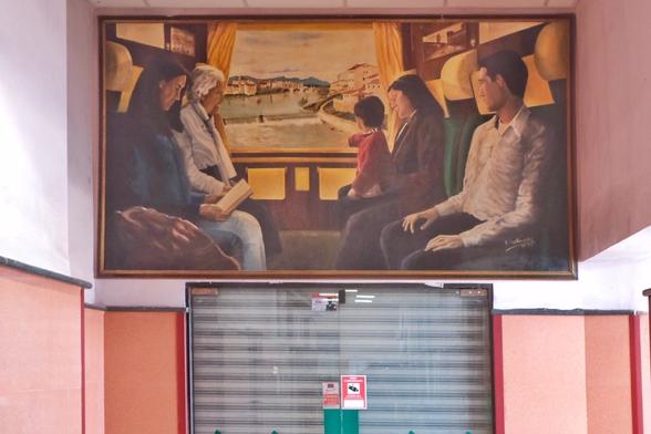 A painting of a train compartment in a hallway of the station building.