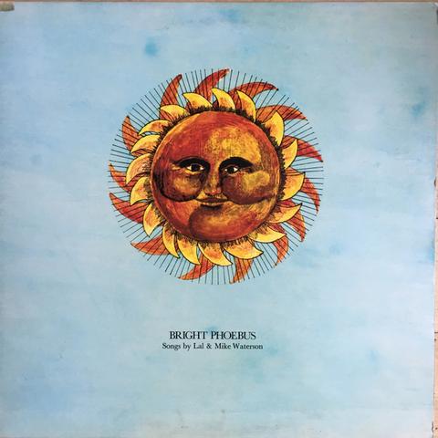 The cover art is a stylized painting of sun in yellows and oranges with a smiling face, in the center of a blue background that looks like a sky. The album name is in black font underneath the sun, with the artists' name are in smaller font below.