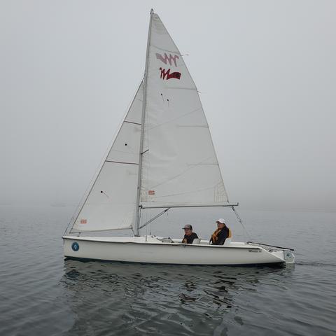 Sailing on foggy ocean on Martin 16, 2 seater sailboat. Mom is in stern seat behind me.