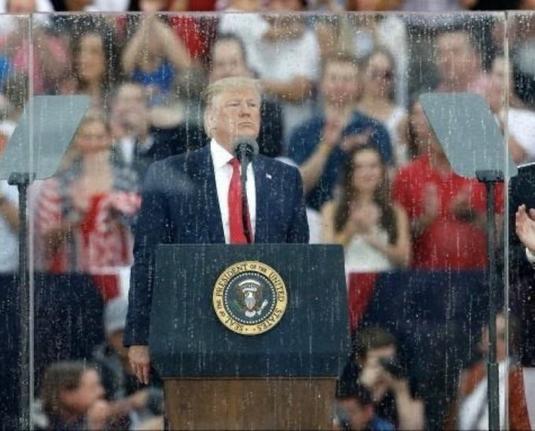 Photo of trump in his cube of bullet-proof glass