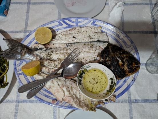 Seabream with no bones, served on a plate with lemon