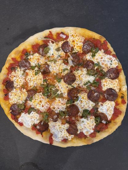 Chorizo, mootz, olive, basil, and onion pizza