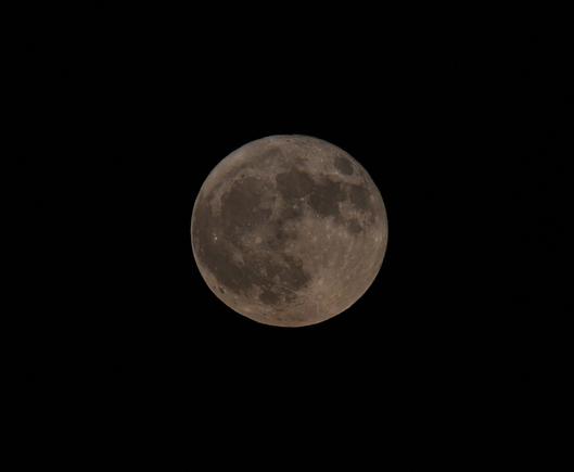 Full moon against a black sky. Tycho crater is visible in the lower south east, with the sea of clouds, ocean of storms, copernicus crater, sea of rains, sea of serenity and sea of tranquility swirling from Tycho from left to right across the face of the moon.