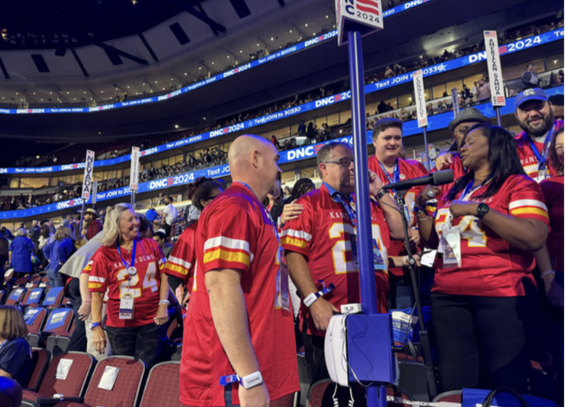 Kansas City delegates in red and yellow chiefs football team jerseys
