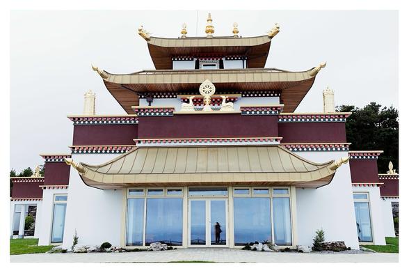 Myself and the ocean reflected in the sea facing windows of the temple’s facade.