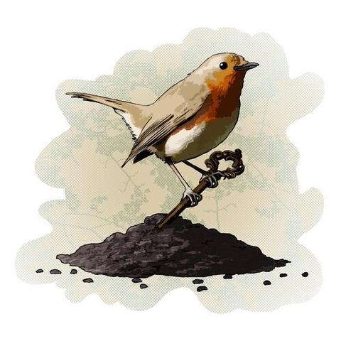 A red brested robin sits on an old key sticking up out of a pile of dirt