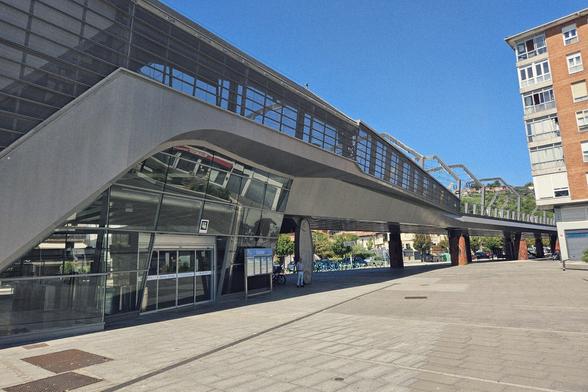 The elevated Euskotren Loiola station from the outside with a grey stainless steel outlook.