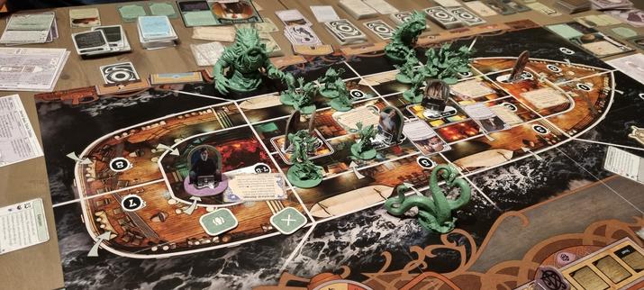 Photo of the end state of a game of Unfathomable (with the From the Abyss expansion). There are many deep ones on board the ship.