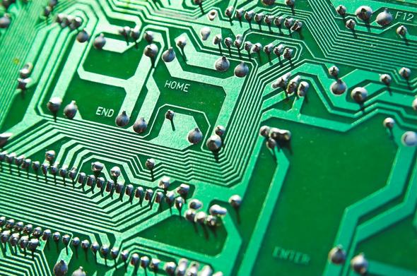 Close-up image of a green printed circuit board.