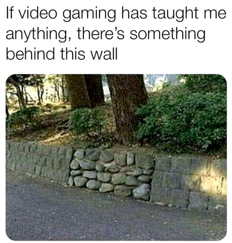 Photo shows a retaining wall that mostly made of rectangular blocks, but there's a section made with round river rocks. The caption applies to the river rock: If video gaming has taught me anything, there's something behind this wall
