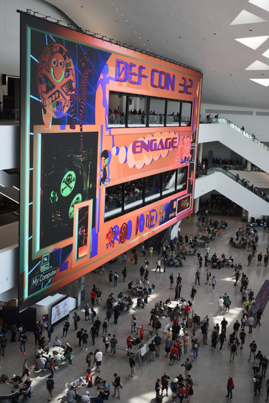 DEF CON 32 video wall with the word ENGAGE highlighted.