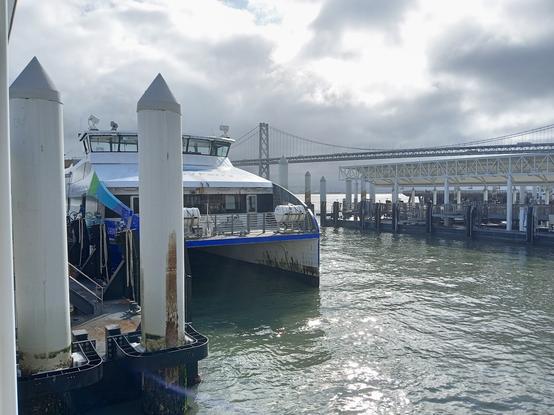 The ferry to Richmond at the SF Ferry Building.  Bay Bridge in background.  Dramatic sky!