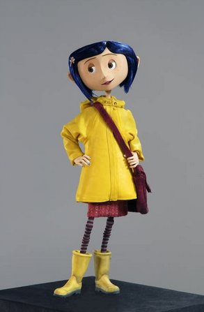The puppet of Coraline in her yellow coat and swampers with her mauve messenger bag.