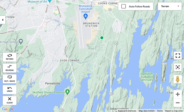 A topo map (land in green and grey, water in blue) of Brunswick, Maine. Near "Brunswick Station" / Brunswick Executive Airport (the Brunswick Naval Air Base) is a green dot indicating the location of Picnic Pond. One can see that streams empty into the ocean approximately 2 miles away. Downstream are several nature preserves.