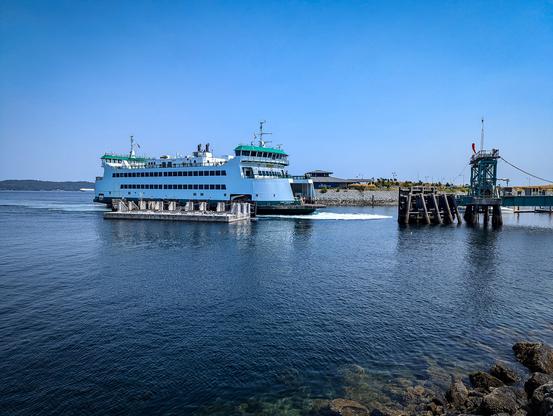 Photo shows a Washington State Ferry approaching the Point Defiance Ferry Dock.