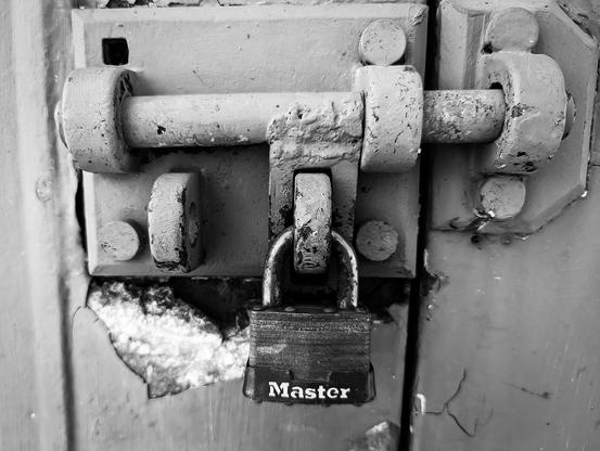 Point Robinson lighthouse. The photo shows a lock and latch to the door of a shed near the lighthouse. The photo is black and white.