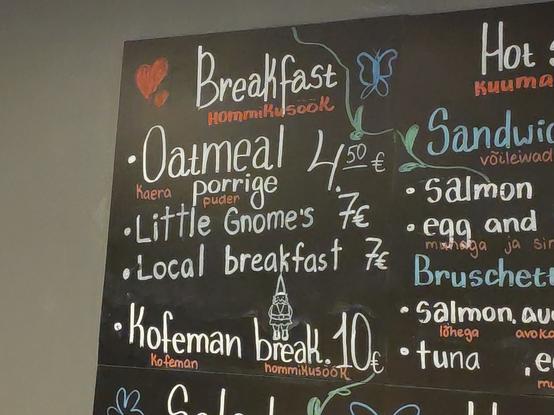 Breakfast menu on a blackboard, with “Little Gnome’s breakfast” as one of the choices