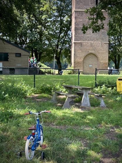 Kinderfiets.

Met zijwieltjes en de scouting op de achtergrond.

Oja, en een oude toren die luistert naar de naam ‘Oude Toren’.