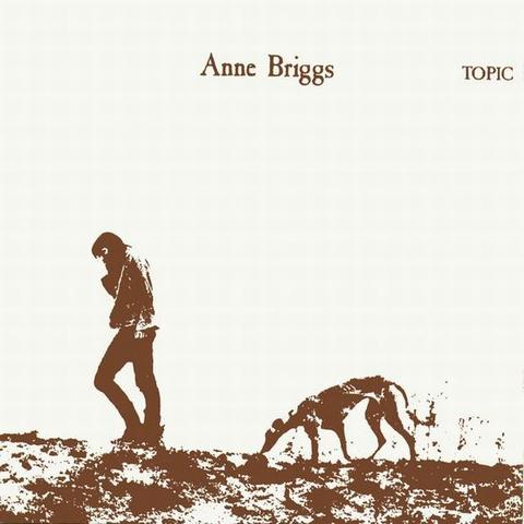 The cover art is a monochrome image, like a photograph has been photocopied a number of times. The photo is of a person with long hair, wearing pants and a jacket, walking. A tall skinny dog (perhaps a greyhound, or wolfhound) walks behind, with its nose to the ground. The artist's name is in the same colour at the top center, and the record label name is in smaller font to the right.