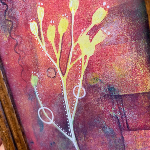 Monotype print using a selfmade gelli by aab_art via r/printmaking on reddit: Yellow and white silhouetted flowers with long stems against a highly textured crimson and multicolored background