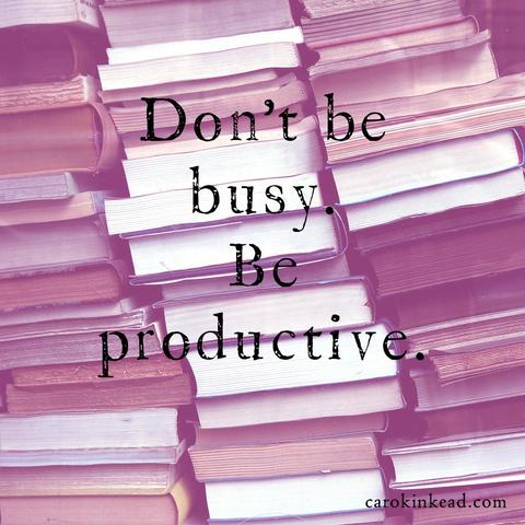 Three tall stacks of books overlaid with a pink filter. On top of that are the words, "Don't be busy. Be Productive.”
