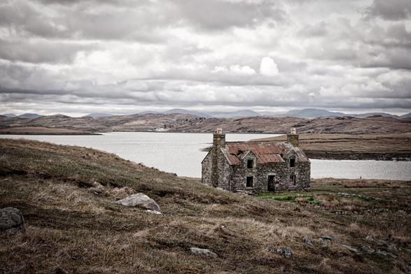 An enduring relic of the Scottish Isles, this house on the Isle of Harris stands amidst a stark, beautiful landscape. With its decaying structure and lonely presence, it invites us to imagine the lives that were once lived within its stone walls, in harmony with the wild and unforgiving environment of the outer Hebrides.
