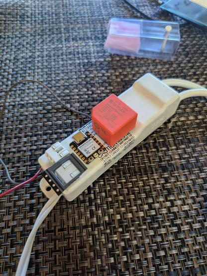 All the components laid out on the back of the transformer. They fit :) The transformer is white, the Zettler cheese block is orange and the ESP is next to that.