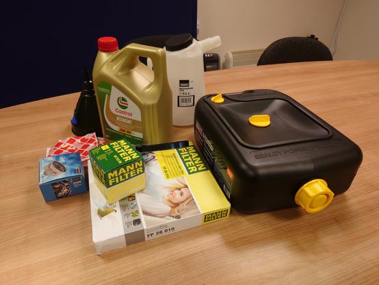 tools and materials for oil service (jug _ funnel, 4 litres of Castrol Edge 5W-30 LL oil, Febi Bilstein sump plug with washer, drain can to catch old oil, filter removal tool, new oil filter and cabin air filter)