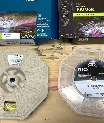 An older plastic fly line spool on the right, and a new compostable paper fly line spool on that left.