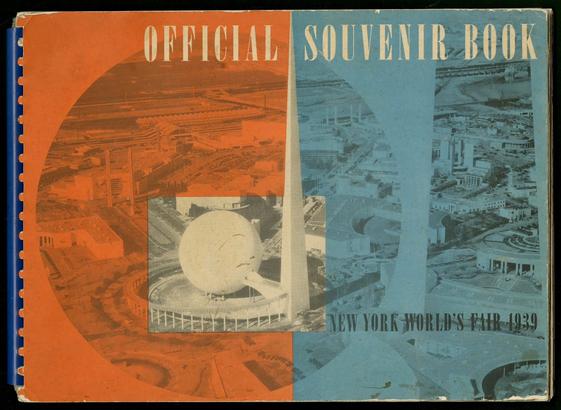 Photo of a book cover. The book is bound in a blue comb binding. The cover is red and blue with black and white photos of spaceage architecture overprinted. The title is “Official Souvenir Book” in large condensed type with “New York World’s Fair 1939” in small type.