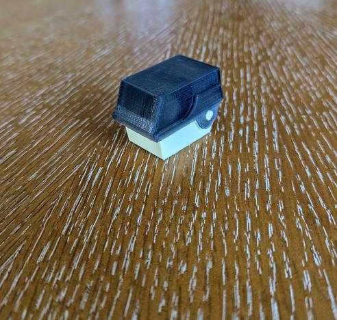 A photo of a miniaturized floppy disk organizer sized for SD cards but it's closed so you can't see the SD cards inside.