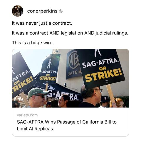 A social media post by user "conorperkins" reads: "It was never just a contract. It was a contract AND legislation AND judicial rulings. This is a huge win." Below the text is an image showing people at a picket line holding "SAG-AFTRA ON STRIKE!" signs in front of Warner Bros. Studio, Gate 4. At the bottom, there is a link preview from Variety with the headline, "SAG-AFTRA Wins Passage of California Bill to Limit AI Replicas."