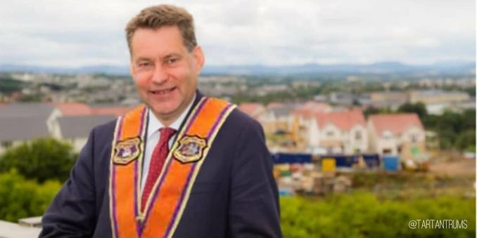 Murdo Fraser wearing an orange order sash and grinning from lug to lug