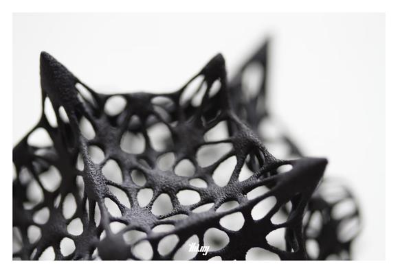 Macro view of a black 3D printed diatom-inspired filigree sphere-like object, created via a recursive subdivision mesh (with displacements) of a seed cube.