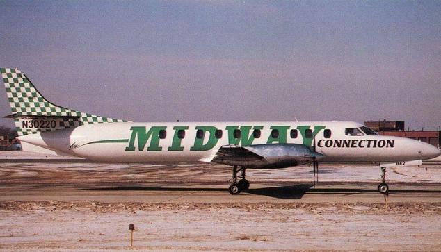 this little prop plane has the airline name down the length of the fuselage. It looks parked on a side ramp