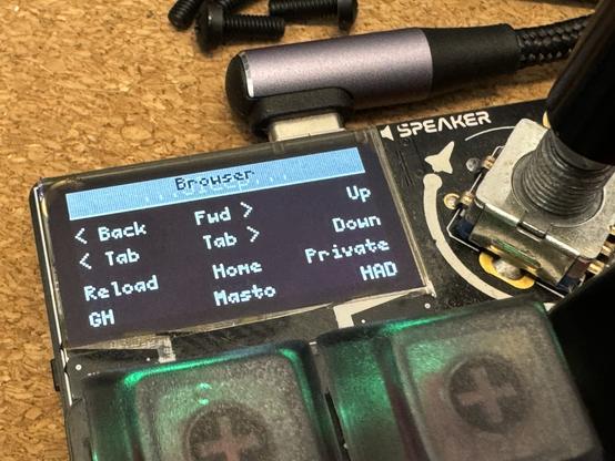 A small OLED display on a macropad. The display is on and shows rows of text laid out to match the patten of the keys. Text at the top shows the word "Browser", with the word "...Sleep..." ghosting behind it.