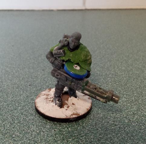 A heavily kitbashed model of a woman weilding a very big gun.