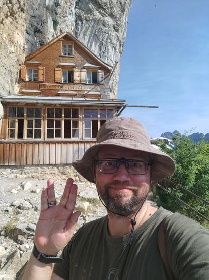Selfie of FlohEinstein doing llap greeting before mountain restaurant Aescher