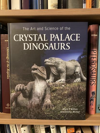 The book "The Art and Science of the Crystal Palace Dinosaurs" featuring two dinosaur sculptures on the front cover.