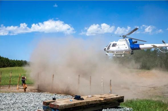 Image from the linked Twin Cities Pioneer article, it's a photo of the CBP helicopter maybe 20 feet off the ground at a Line 3 pipeline pump station near Park Rapids, MN, forcing a choking layer of dry loose soil and debris in all directions