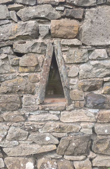 A Drystone Bothy/ Hut/ Byre/ Shed/ wall with a small triangular window opening