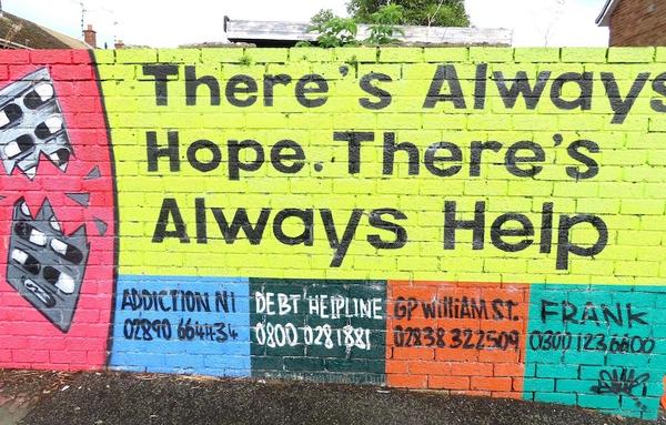 part of a wall-painting with "There's always hope. There's always help." and information about social services