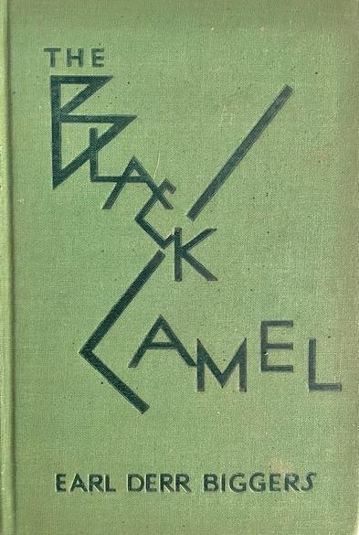 Book entitled 'The Black Cat' by Earl Derr Biggers.  One of the Charlie Chan mysteries, printed in 1929. The green cover of the front board shows the title in a playful, spiky style.