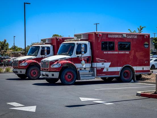 Two firefighter transport trucks from the San Bernardino County Fire Department.

https://sbcfire.org/professionalhandcrew/
San Bernardino County is proud to have Old Cajon Crew 6 and Harrison Canyon Crew 7. Both are professional hand crews that are available to respond to emergencies.

The first San Bernardino County Fire Department professional hand crew was created in July 2012 and consisted of 18 rigorously trained members known as Crew 40. 

"Today, San Bernardino County is proud to have Old Cajon Crew 6 and Harrison Canyon Crew 7. Both crews are available to respond to emergencies 24 hours a day, seven days a week. In addition to their year-round availability, these crews are augmented by seasonal hand crew members six months out of the year for a total of 30 members.

SBCoFD hand crews have become increasingly deployed to various incidents in recent years and serve multiple benefits to the county. In addition to their work in wildland areas, hand crews are assigned to conduct mop-up operations after fires are put out, ensuring that hotspots don’t flare up and the fire is fully extinguished. The hand crew program has also secured numerous contracts with San Bernardino County Land Use Services Department for fuel modification projects.

Hand crew teams can serve multiple roles in fire suppression as they can create firelines, defensible space, and conduct mop-up operations, improving efficiency and relieving firefighters and medic engines to return back to service."