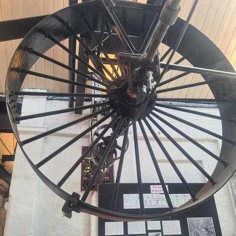 Ceiling mounted flywheel with driving belt