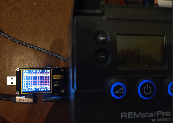 A truly antique CPAP device shown running off of a modern power source.