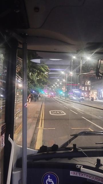 Looking out the front window of a bus on Princes Street at night