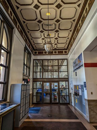 Oroville Main Post Office, interior view of the main service area. The Oroville Main Post Office is the only federal building in Oroville. Although the building had no influence on the development of Oroville's architectural tradition, it remains one of the most monumental buildings in town. The design of the building is a rare example of the transition from the Renaissance Revival style to the Starved Classical style.