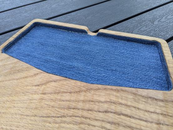 Empty palm rest showing the denim in the keyboard notch